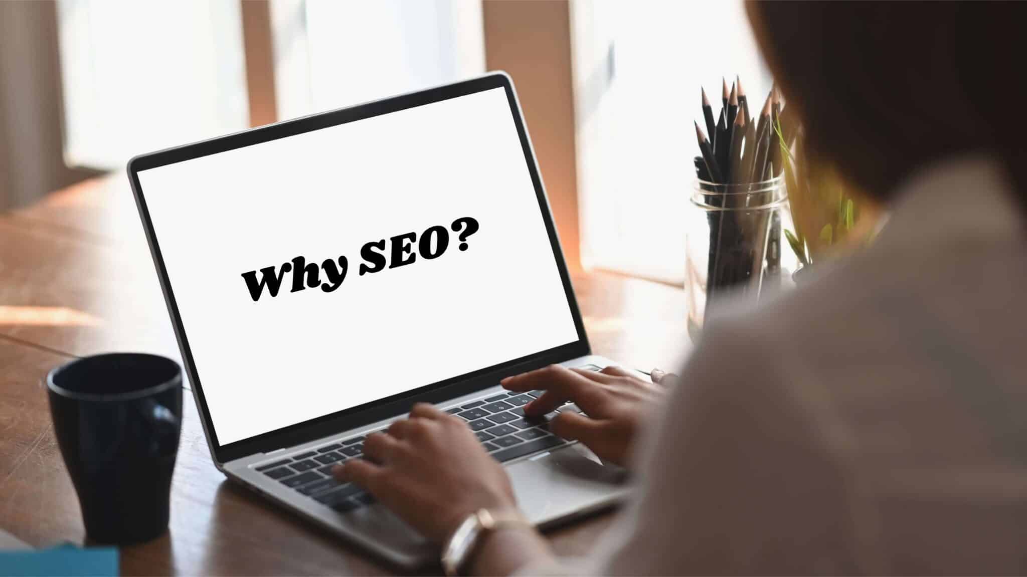 woman facing laptop with words why seo on it